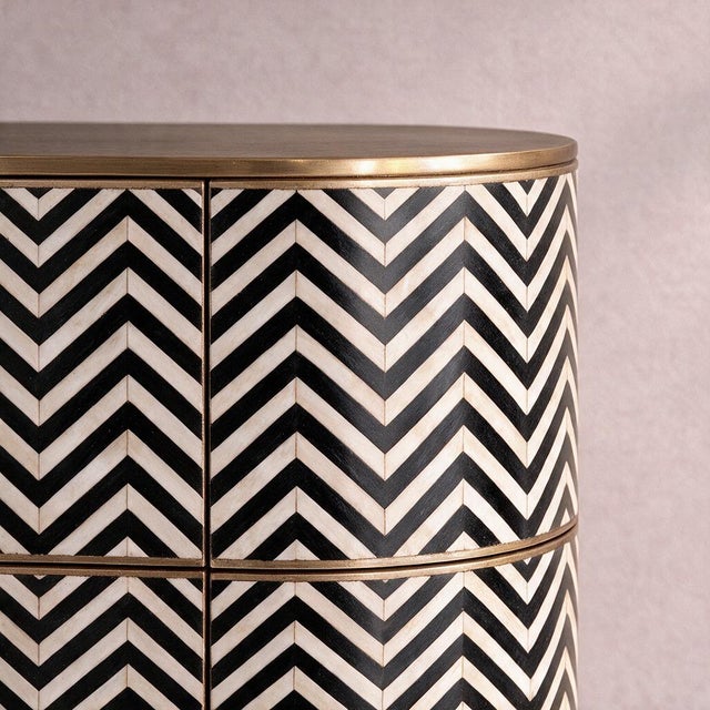 The Veyra Chevron Bone Inlay Six-Drawer Dresser explores the graphic precision of Art Deco design through a striking black...