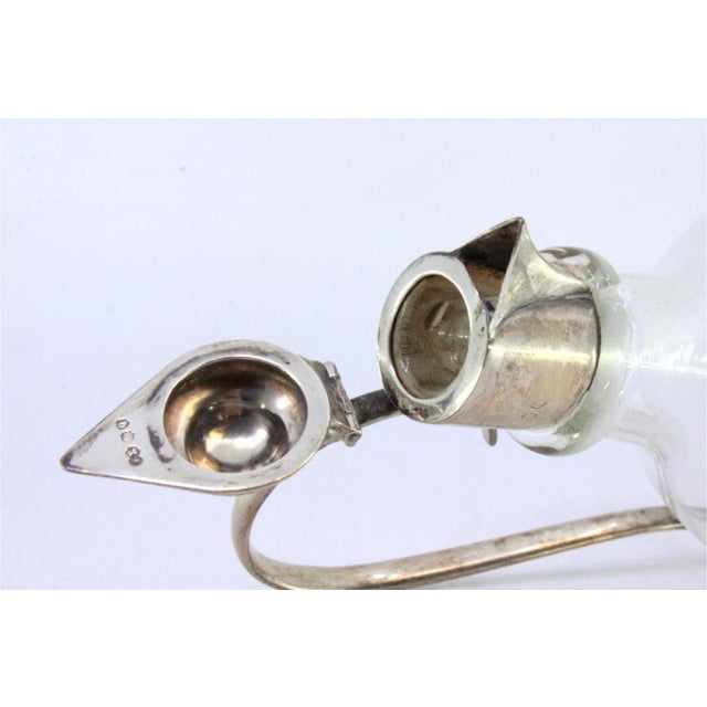 Glass Wine Jug with Smooth Silver Frame and Knob, in Very Good conditions. Designed 1890 to 1919 This piece has an...