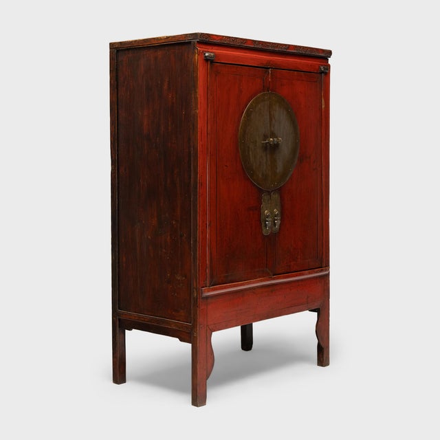 Crafted in the mid-19th century, this striking red lacquer cabinet was likely part of a traditional wedding dowry,...