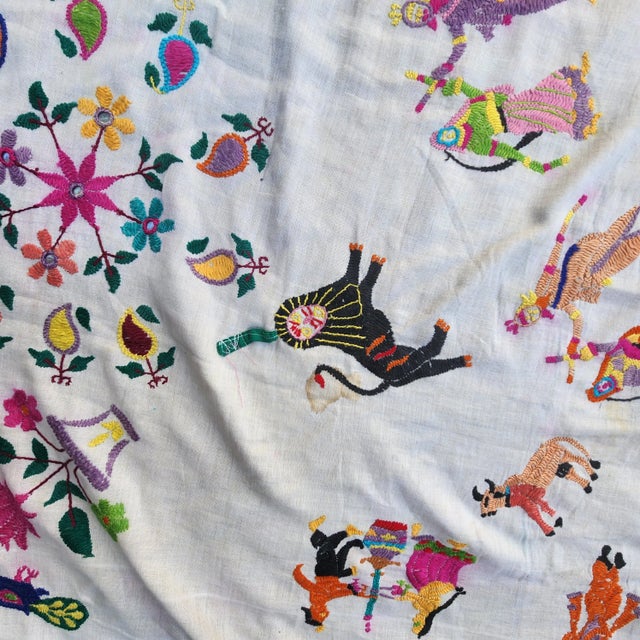 Dating from the 1950s this tablecloth is beautiful. Hand embroidered with flowers and Hindu gods. Great as a beach blanket...