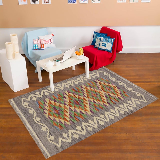 Elevate the elegance of your home with this stunning hand-woven tribal Kilim wool rug. Meticulously crafted on a loom by...