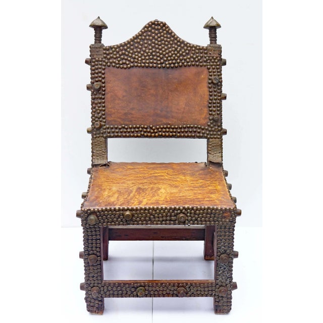 African Ashanti tribe chiefs chair. Highly decorated with brass tacks and pressed brass decorations. Hardwood with vellum...