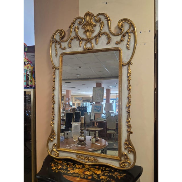 Georgian-style mirror. Elegant decorated wooden mirror. Lacquered wooden frame with gold-leaf decorations and curls....