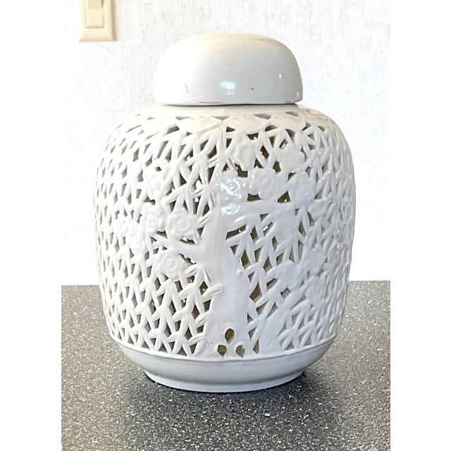 Measures about 8.25 inches tall and has diameters of 2.5 across the top opening and about 4 inches across the bottom base....