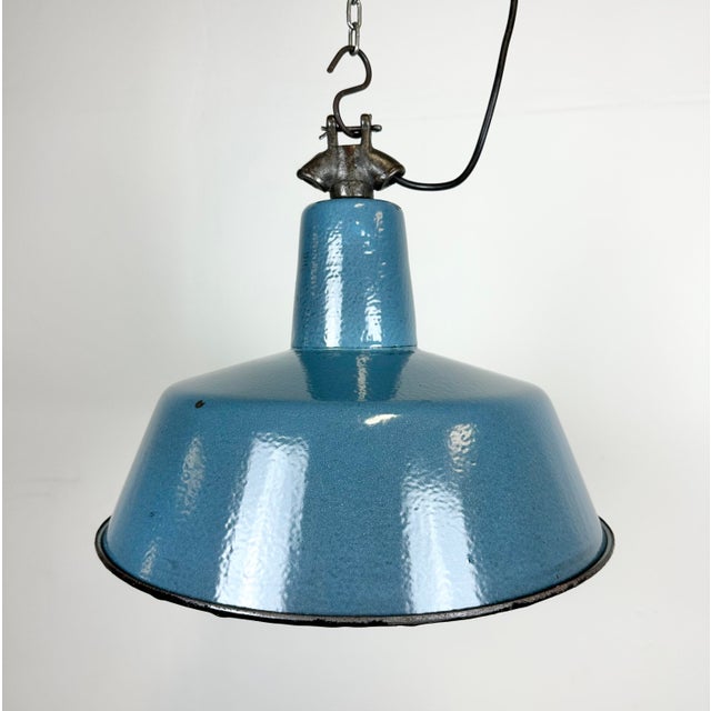 Industrial blue enamel pendant light made by Polam Wilkasy in Poland during the 1960s. White enamel inside the shade. Cast...