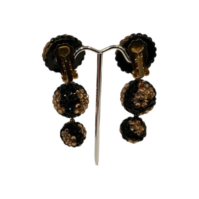 Add a touch of vintage glamour to your outfit with these exquisite 3 ball drop earrings by Richard Kerr clip-on earrings....