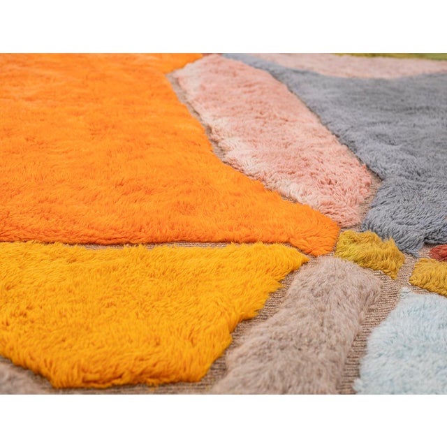 A radiant patchwork of color, held together by confident geometry. This large hand-knotted Moroccan rug divides its...