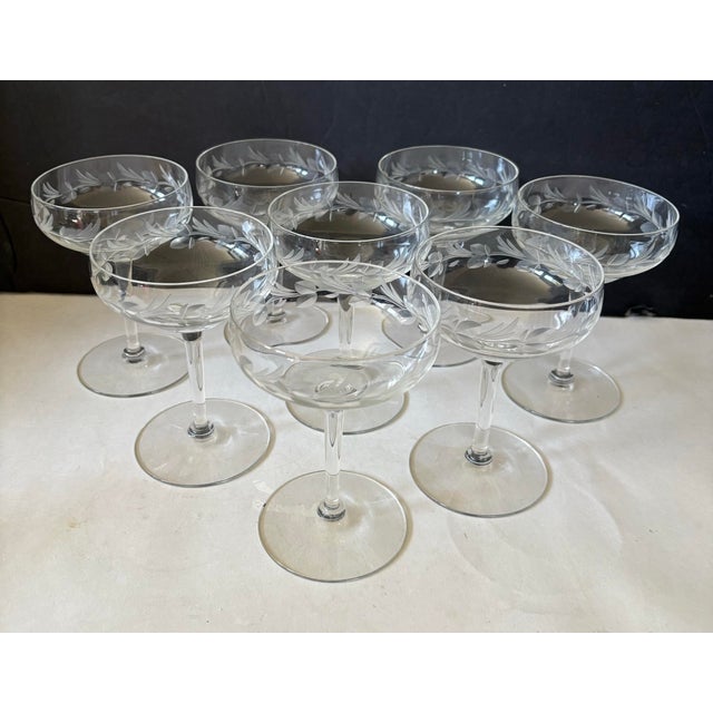An elegant set of eight vintage crystal champagne coupes featuring beautifully frosted floral and botanical etching...