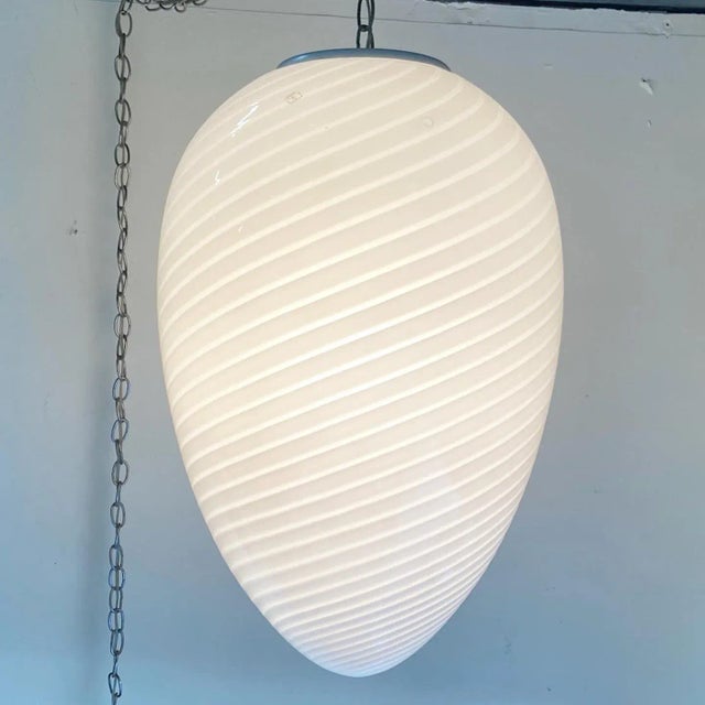 Outstanding vintage Murano glass hanging egg lamp. Features a fantastic swirl and let me tell you, this was one of those...