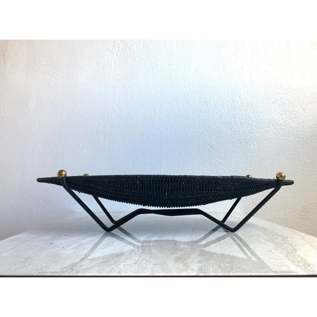 We love the modernist styling of this vintage wicker basket. It features a boat shape in black woven natural fiber, and it...
