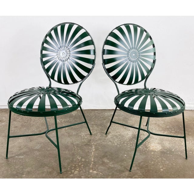Pair of iconic antique iron sunburst metal garden chairs also referred to as "pinwheel spring" chairs, "Casablanca" or...
