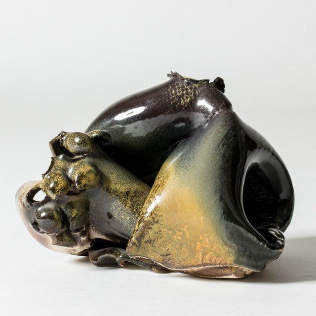 Unique stoneware sculpture by Bengt Berglund, in an abstract, organic form with a hole with frayed edges. Blue, aubergine...