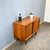 A sleek and elegant sideboard – made in Germany with beautiful details such as the recessed teak handles. The sliding...