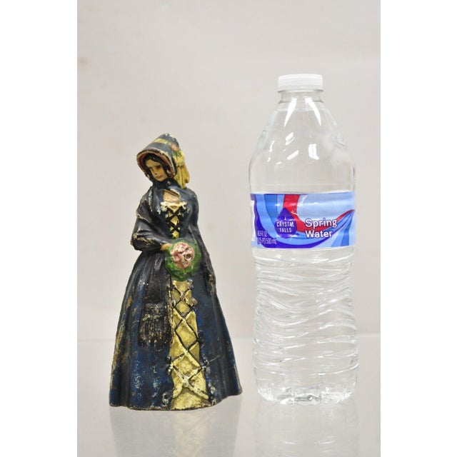 Antique Victorian Cast Iron Figural Colonial Woman Painted Door Stop. Circa Early 1900s. Measurements: 7" H x 3.5" W x 3" D.