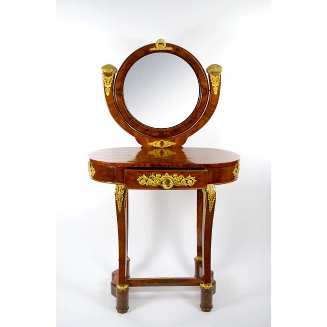 Antique oval shaped ladies mahogany dressing table in the Louis XV style with mirror and numerous gilt bronze mounts with...