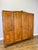 A handsome Vintage French Louis wardrobe in oak, featuring four tall panelled doors with carved decorative motifs, a...