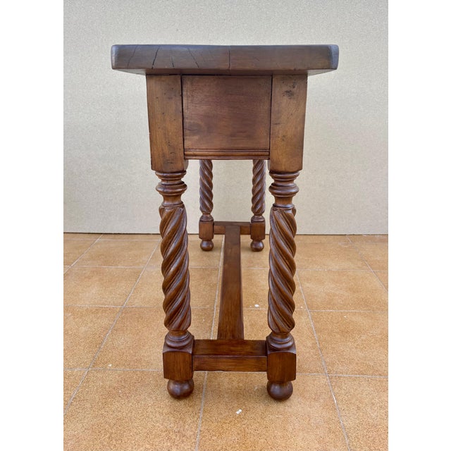 Characterful Spanish console table crafted in hardwood, featuring beautifully carved drawer fronts and elegant barley...