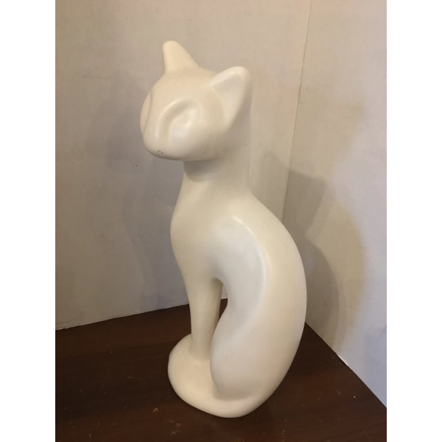 Classic vintage mid-century matte white cat figurine. Sleek in style, this sculpture is a bit rare in that it is a smooth...