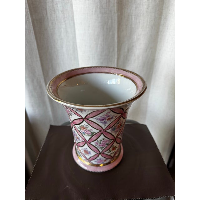 Vintage Andrea by Sadek porcelain vase featuring a pink cross-lattice ribbon design outlined in gold with hand-painted...