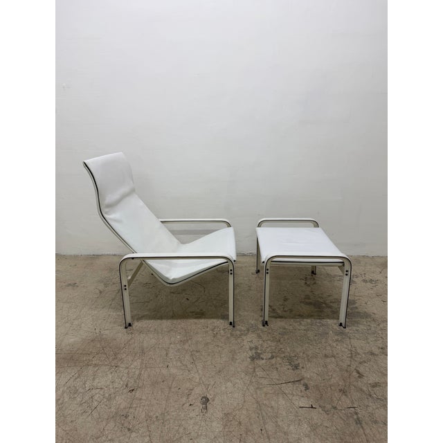 Original saddle-stitched, white leather lounge chair and ottoman on white leather wrapped aluminum frame designed by...