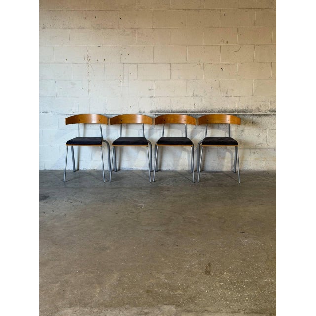 These versatile stacking chairs combine curved wooden backrests with tubular steel frames and cushioned seats. Their sleek...
