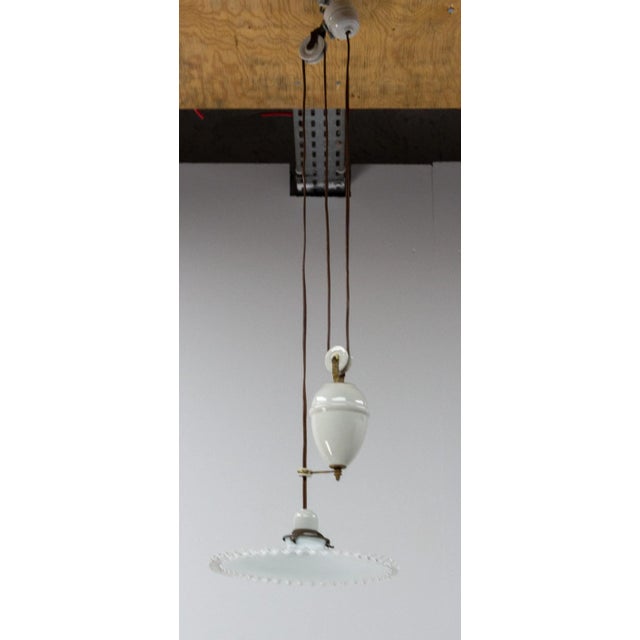 Ceiling pendant lamp in glass and opaline early 20th century. French counter weight chandelier. White glass diffuser and...