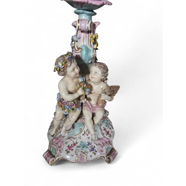 Elegant German porcelain clock set, dating to circa 1900, comprising a central mantel clock accompanied by its original...