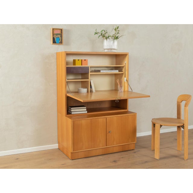 Classic two-part secretary desk from the 1960s. High-quality body made of ash veneer with a hinged work surface, an...