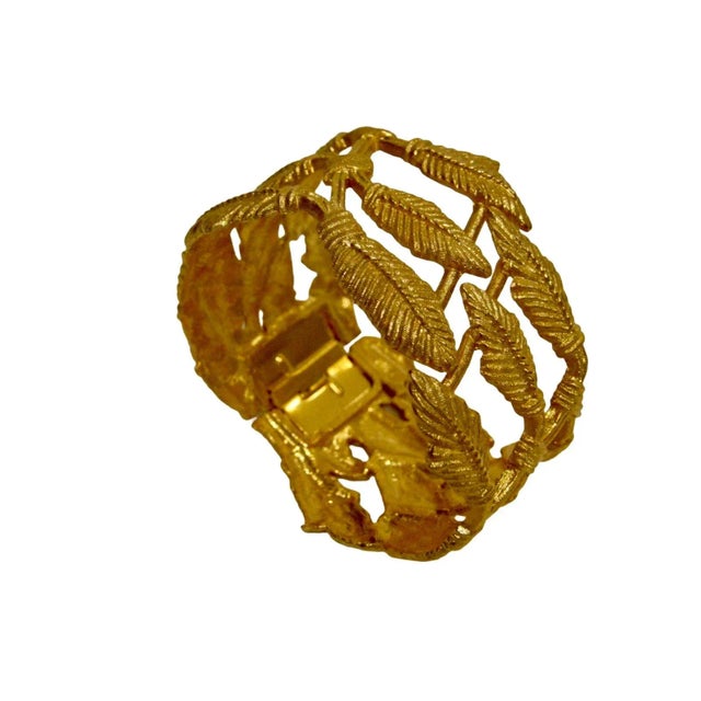 1980s left motif gold plated classic spring clamper bracelet , 6.75 interior circumference, 8" exterior circumference...