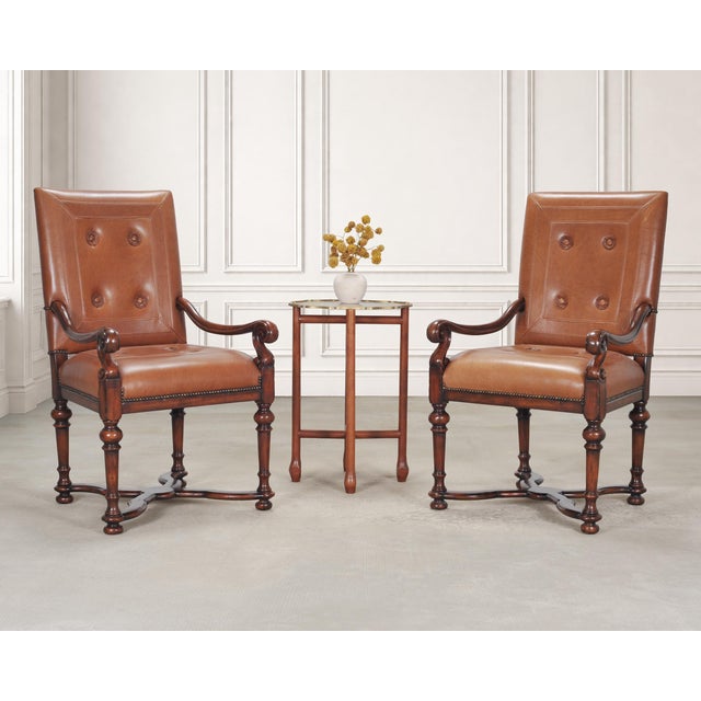 A grand pair of leather and mahogany armchairs or throne chairs crafted in the French Louis XIII, or Baroque taste by...
