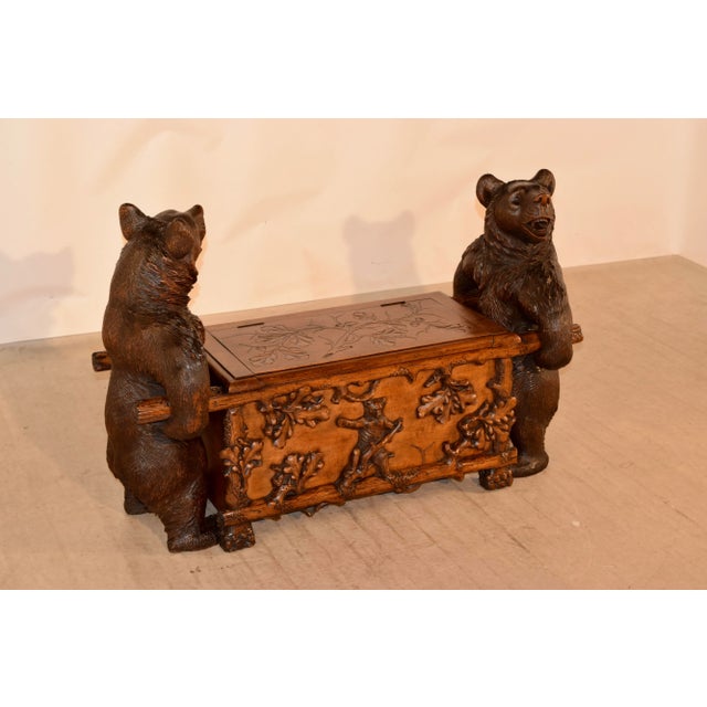 An excellent example of a 19th century Black Forest carved wooden bear bench from Switzerland made from linden wood. The...