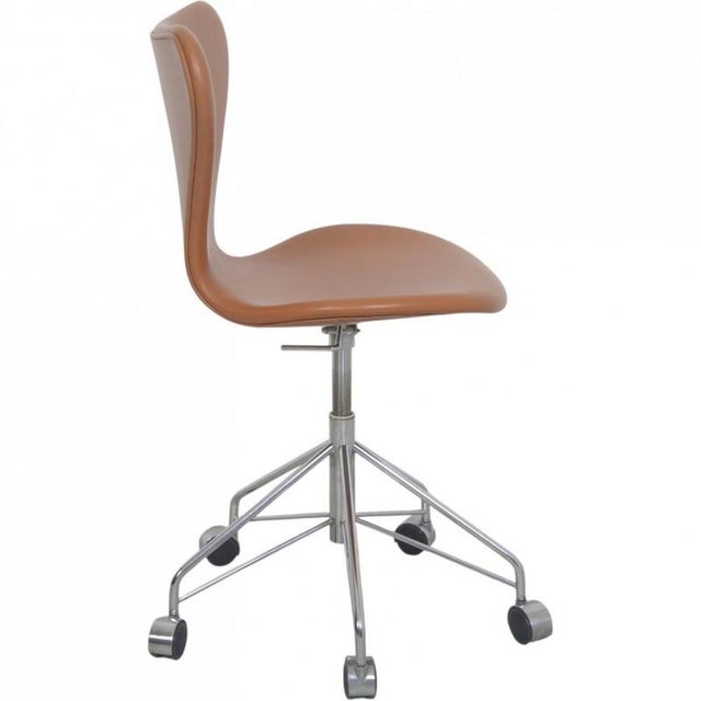 Arne Jacobsen 3117 office chair upholstered in cognac classic semi anilin leather. The chair is from the 1980s but was...
