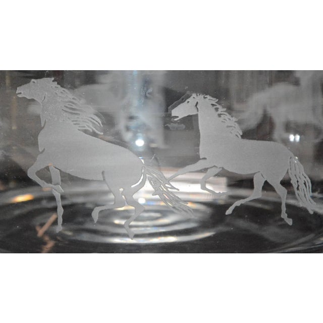 This is a very heavy, clear glass bowl with prancing horses etched on the outer rim. The bowl is not marked. The glass...