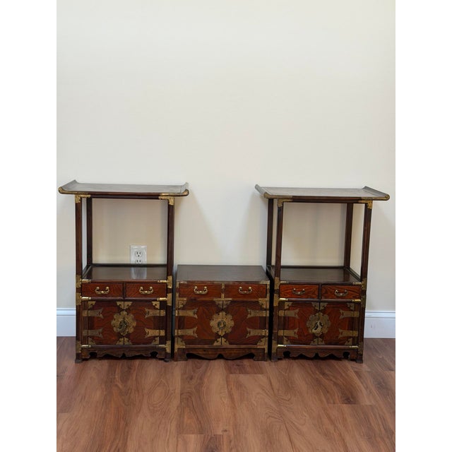 Vintage Asian-inspired pagoda style display cabinet set in dark stained wood with brass mounts and hardware, comprising a...