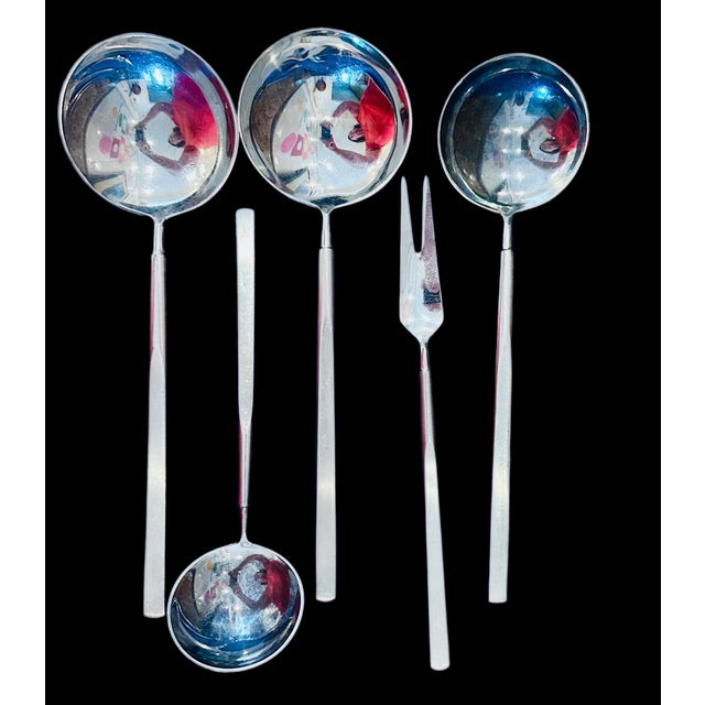 A 165- piece "Obelisk" stainless steel flatware set designed by architect Erik Herløw (Danish, 1913–1991) in 1954 for...
