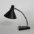 This model with the black shade is adjustable thanks to a flexible arm and an adjustable shade. the paint on the hood is...