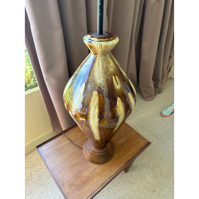 This is a very tall and impressive mid century modern table lamp, with a pale yellow and chocolate brown drip glaze and...