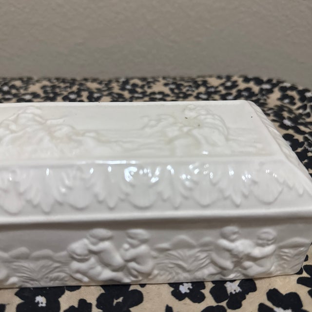This elegant, elongated rectangular trinket box is a fine example of Neo-Classical revival style, likely mid-century...