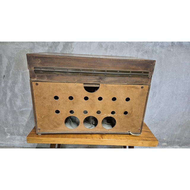 A distinctive vintage radio gramophone housed in a richly figured wooden cabinet, featuring bold geometric proportions,...