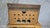 A distinctive vintage radio gramophone housed in a richly figured wooden cabinet, featuring bold geometric proportions,...