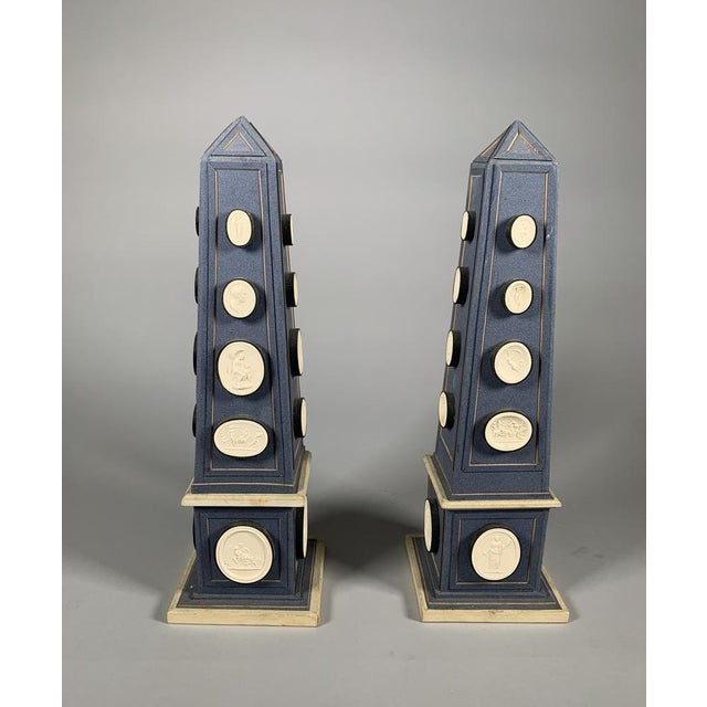 Pair of obelisks adorned with plaster cameos Italian work, late 18th century The cameos depict scenes in the classical...