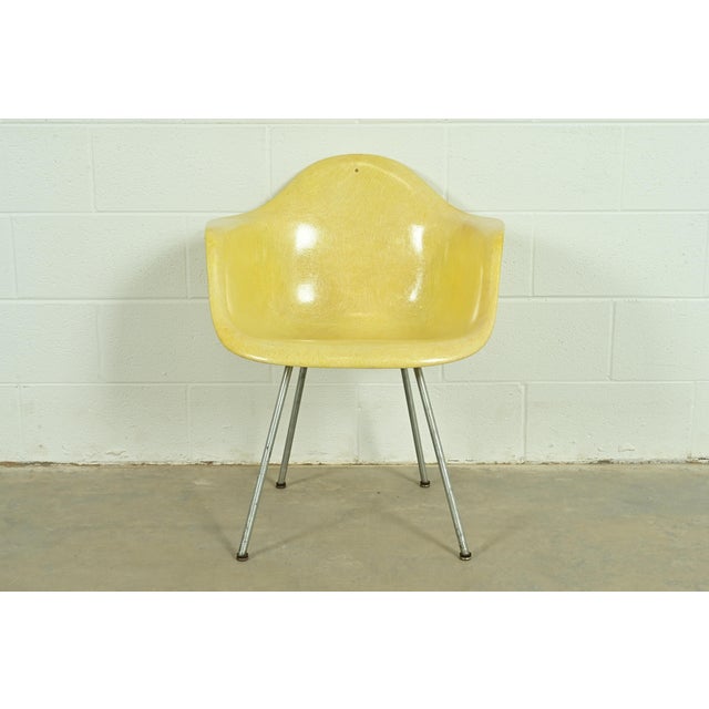 An iconic Mid-Century Modern DAX arm chair By Charles Eames for Herman Miller USA, Circa 1950s Yellow fiberglass, with...