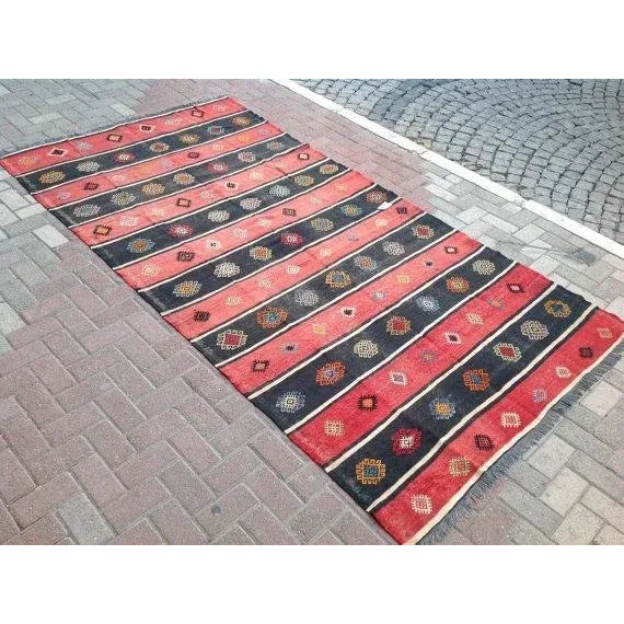 This beautiful, traditional vintage, flatweaved Turkish kilim rug is approximately 60 years old. It is handmade of very...