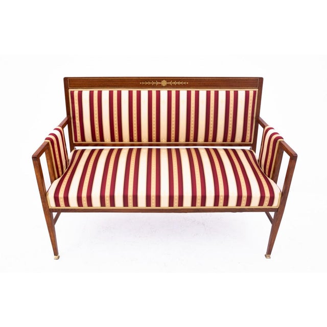 An elegant french salon set dating to around 1890. The set comprises a sofa and two armchairs, all featuring a harmonious,...