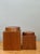 This refined set of two vintage square wood storage boxes reflects the timeless appeal of minimalist mid-century design....
