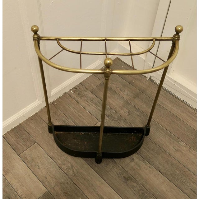 Curved brass & iron stick stand or umbrella stand. A charming piece, and it has a very unusual elliptical half moon shape,...
