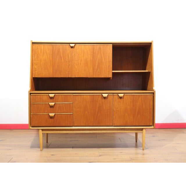 A stunning tall credenza by renowned furniture maker Austinsuite, this Mid Century Modern Vintage Teak Tall Credenza...