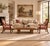Elegant pair of Empire-style walnut armchairs featuring gracefully curved arms, carved turned arms supports, and rolled...