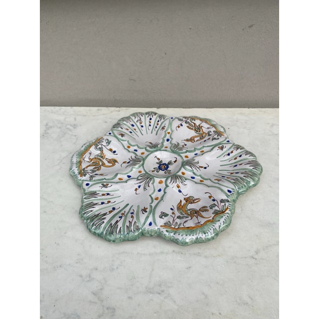 French Faience rustic oyster plate Moustiers style, circa 1940. Painting of birds and flowers.