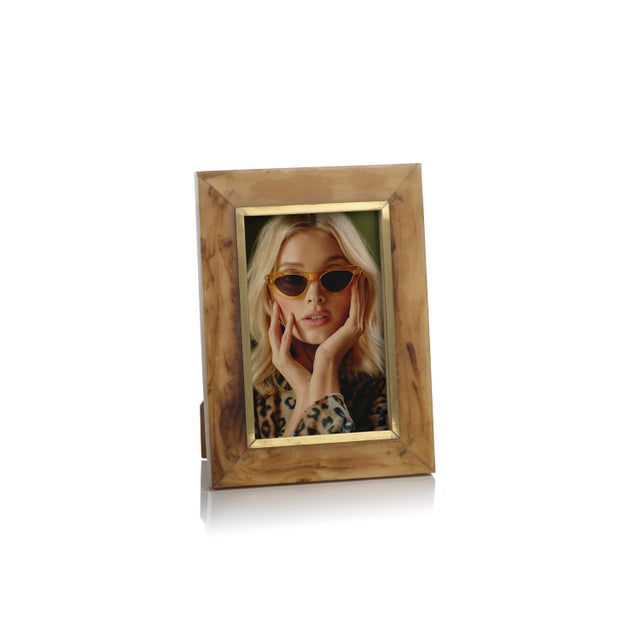 Beautiful brown frame features matt gold brass accent and holds 4 inches x 6 inches photo inserted through back of frame....